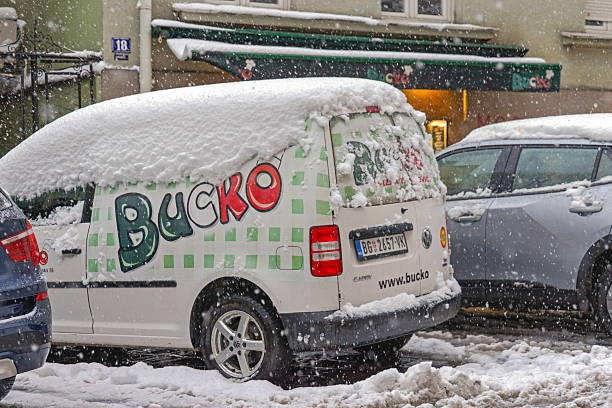 Belgrade, Serbia - January 04, 2026: Delivery Wan Under Snow Italian Restaurant Bucko Pizza Cold Weather Winter Day Bad Weather in City Centre.