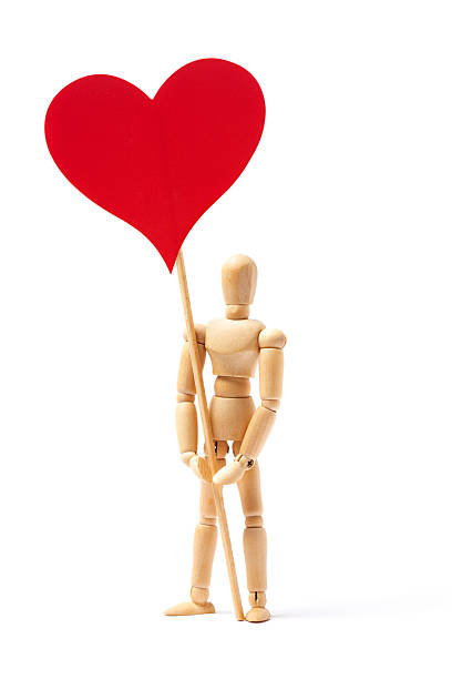 Wooden Figurine With Heart Shape Paper Box Against Pink Background
