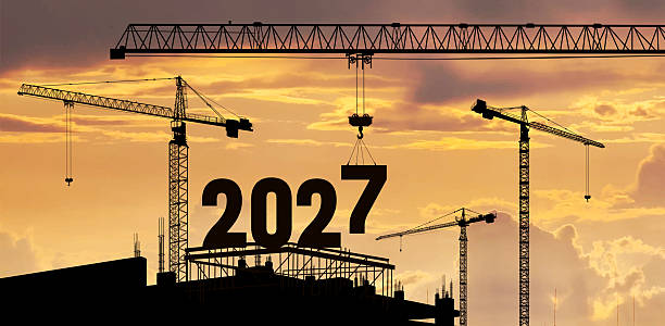 istock Construction crane lowering number 7 to form 2027. New Year 2027 concept with silhouette construction site, teamwork and cooperation. Sunrise sky. Vector symbolizing preparation and new beginnings. 2257132764