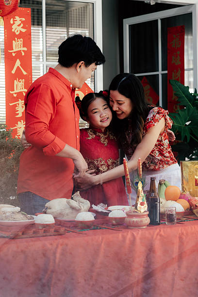 Father and mother hugging daughter warmly at the altar table