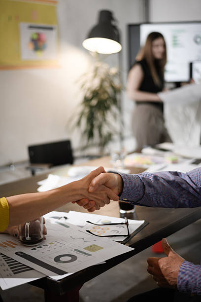 istock Business meeting involves handshake in office setting highlighting collaboration and teamwork during important negotiations in a modern space 2257133930