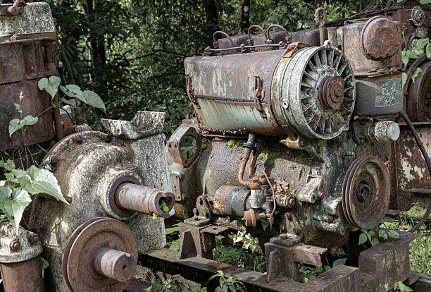 Rusty metal old machine in abandoned outdoor. Broken and rustic machine left over in abandon, Old machine made of steel and used in the mining industry, Space for text, Selective focus.