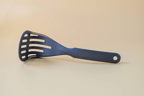 istock Black potato masher on background. Kitchenware. Pusher for mashed potatoes. 2257138340