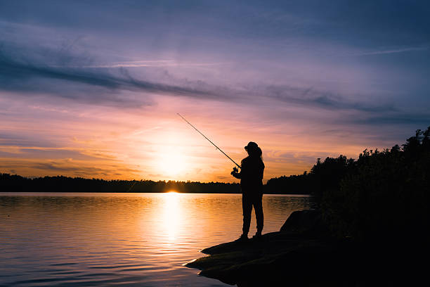 istock A man is fishing in a lake at sunset 2257145980