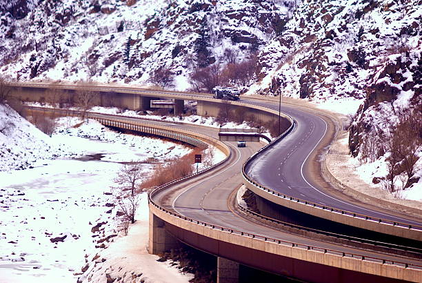 California highway 1-80 through Donner Summit, near where the historical Donner party was stranded and on the way east to Lake Tahoe - Curve and a few cars.