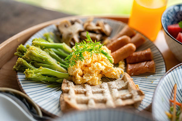 Healhty breakfast meal with omelet egg, bread, mushroom and vegetable.