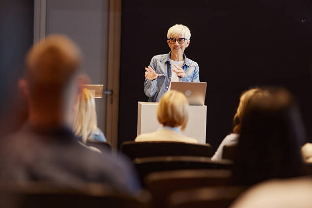 istock Happy senior public speaker talking on a conference at convention center. 2257166775