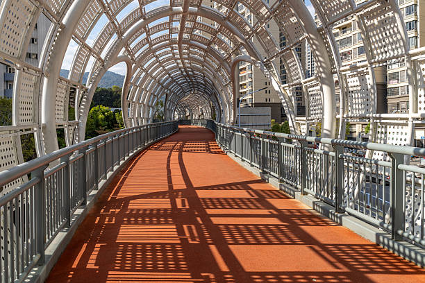 Circular hollow skybridge canopy and red asphalt road
