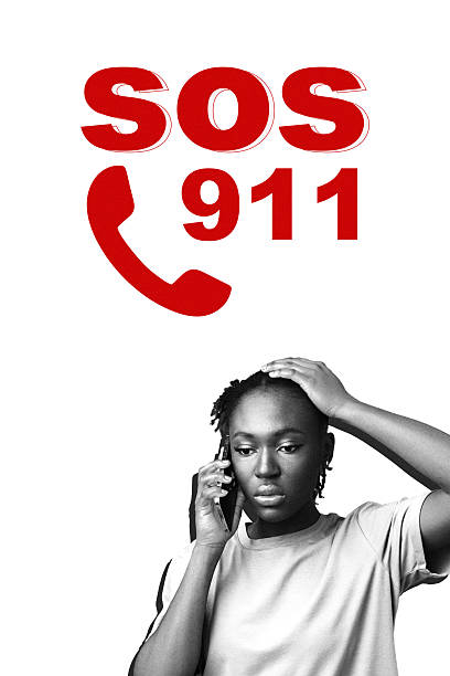 A person is on a phone looking worried while signaling for help during an emergency.