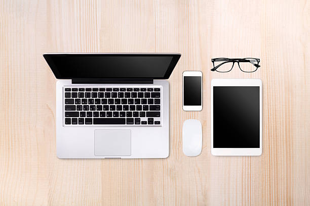 Laptop tablet and smartphone on wood table background with text space and copy space