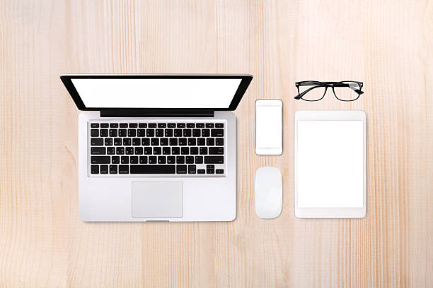 Laptop tablet smartphone and eyeglass on wood table background with text space and copy space