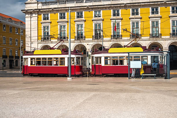 Lisbon, Portugal, Praça do Comércio with a vintage red retro tram, a popular touristic attraction.