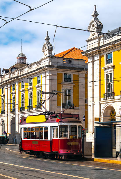 Lisbon, Portugal, Praça do Comércio with a vintage red retro tram, a popular touristic attraction.