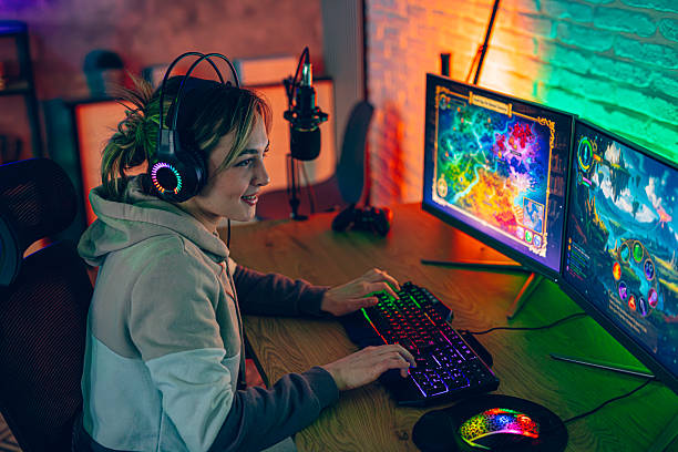 A young gaming influencer plays a fantasy PC game at home while wearing a headset and using a colorful RGB keyboard in a modern setup.