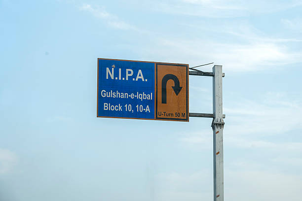 Karachi, Pakistan - December 14, 2025: Road sign board at rashid minhas road. Nipa Chowrangi