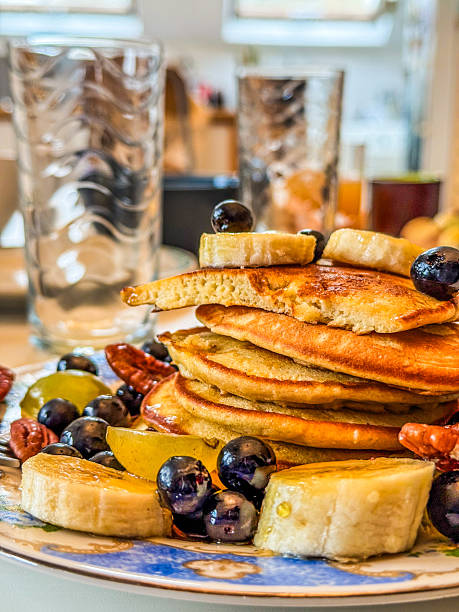 Stack of pancakes with fresh fruit and syrup