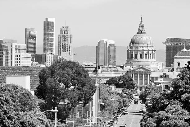Grand historic City Hall building with visitors walking around the civic plaza in San Francisco California