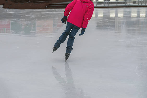Man skating on ice in dynamic pose wearing bright training outfit. Concept of professional skating, winter coaching and ice sport instruction