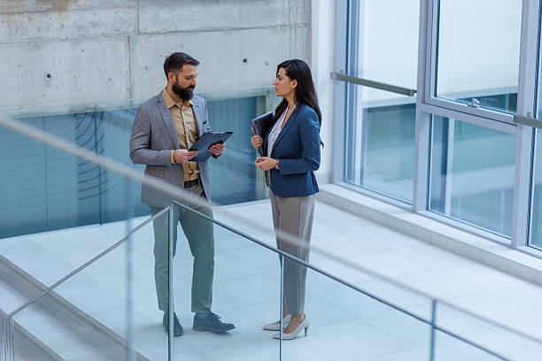 istock Business professionals discussing work in modern office building 2257204071