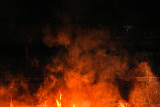 A black background with orange smoke and fire. Scene is intense and dramatic
