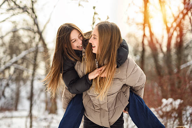 The Two friends outdoors in a cold winter weather.