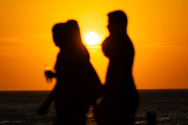 Salvador, Bahia, Brazil - January 2, 2026: Silhouette of unidentified people during sunset on the horizon of the sea in the city of Salvador, Bahia.