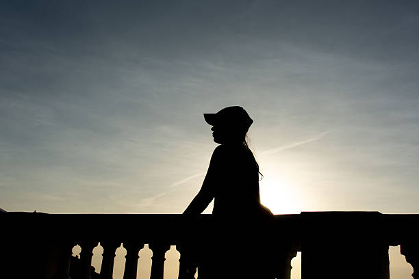 silhouette of a back view of a  woman walking  on white background