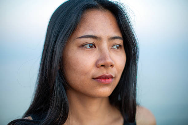 istock Asian woman thinking while looking away outdoors 2257217298