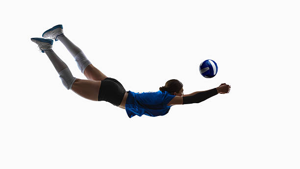 Volleyball athlete performing extended forward dive reaching for ball mid-air. Concept of emergency defense drills, libero technique, coaching materials, fast-reaction programs and match-prep content.