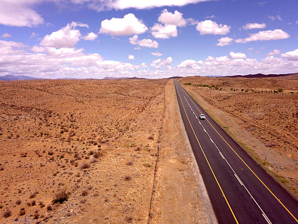 Road goes into the distance on an open landscape.
