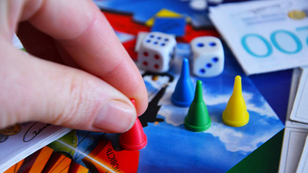 child, girl 5 years old fun playing with colorful wooden figures, toys and blocks on table, early education and creative play, fine motor skills, creative play time