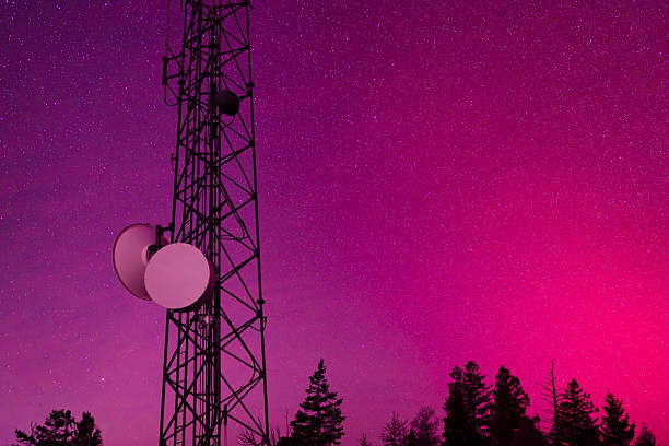 Aurora borealis illuminates the night sky above a telecommunications tower, symbolizing the effects of space weather and geomagnetic storms on modern technology. Solar activity and charged particles interacting with Earth’s magnetic field can disrupt radio signals, GPS, satellite communications, and power infrastructure. This image represents electromagnetic interference, grid vulnerability, and the growing dependence of digital systems on stable space and atmospheric conditions.