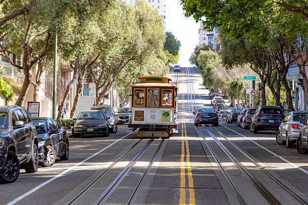 San Francisco, USA - April 30, 2019: people enjoy riding with the cable car in San Francisco.