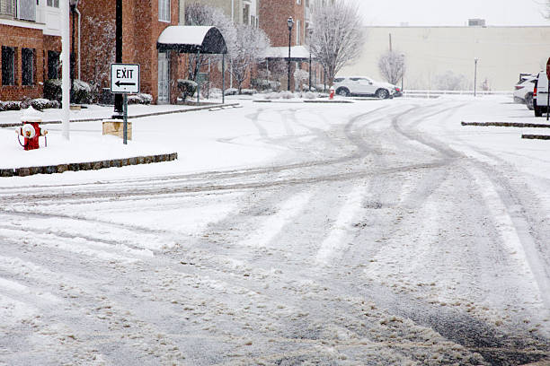 View of a residential area parking lot after a snowfall.