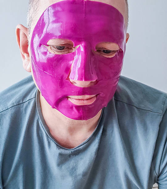 Caucasian man wearing a moisturizing face mask.