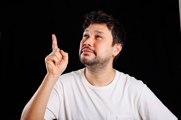 Portrait of smiling, bearded man, showing finger up having good idea . Surprised young bearded handsome man standing over isolated white background pointing finger up with successful idea