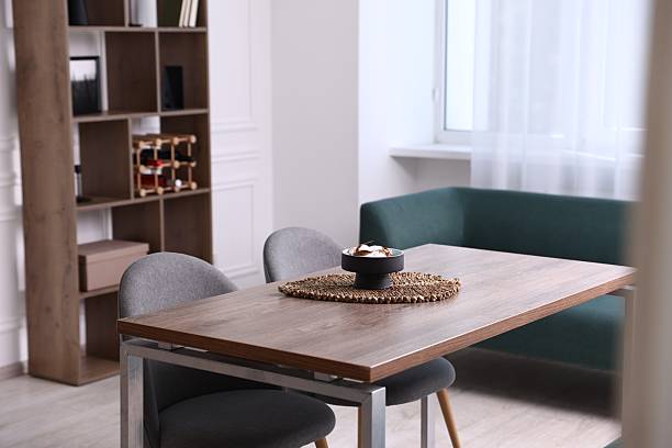 Wooden table with chairs and decor in dining room. Interior design