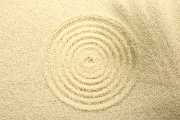 istock Zen rock garden. Circle pattern on beige sand, top view 2257284556