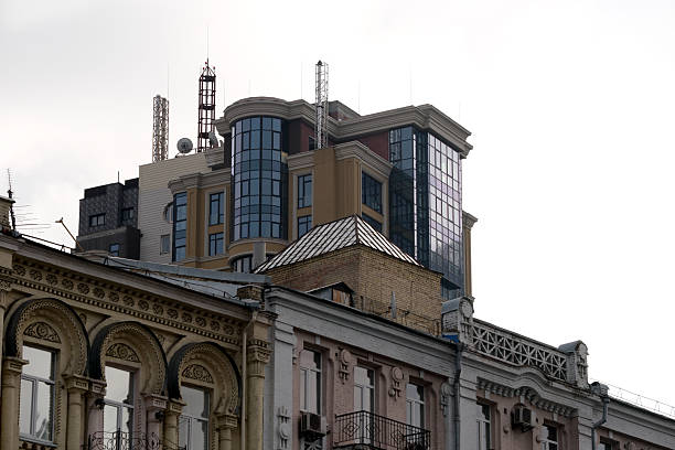 Tall, sleek buildings rise above historic structures in a lively urban setting. Kyiv, Ukraine. December 12, 2025.