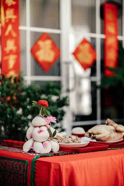 Chinese New Year offering table with symbolic foods and decorations