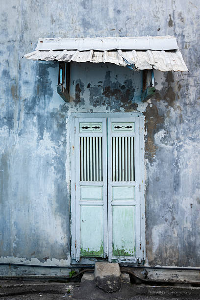 istock Worn wooden door on the wall. 2257303765