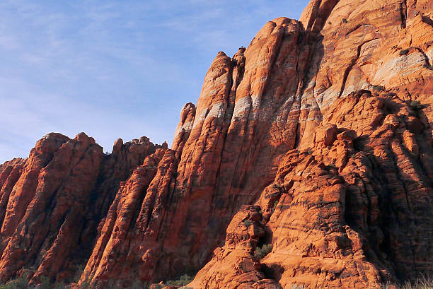 Snow Canyon State Park in St. George, Utah.  Navajo Sandstone is normally an orange-red color is due to the high iron content. In places, the iron has been leached out by warm groundwater, leaving stripes of white. 2014.