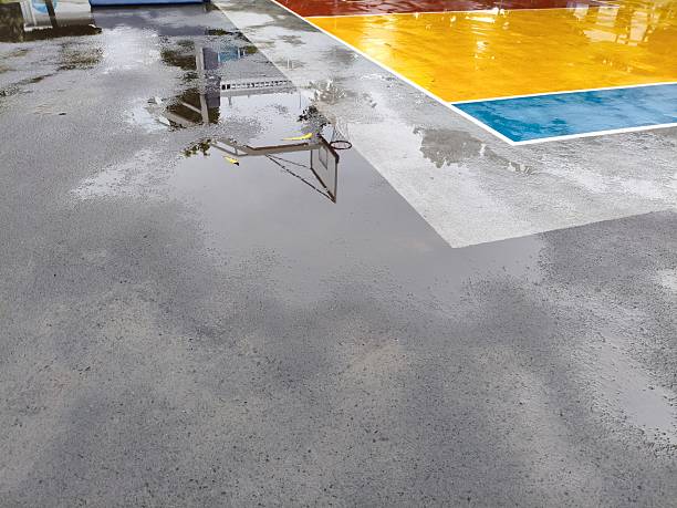 Wet Basketball Court Reflections After Rain