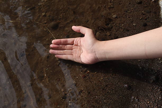 Touching a clear stream water