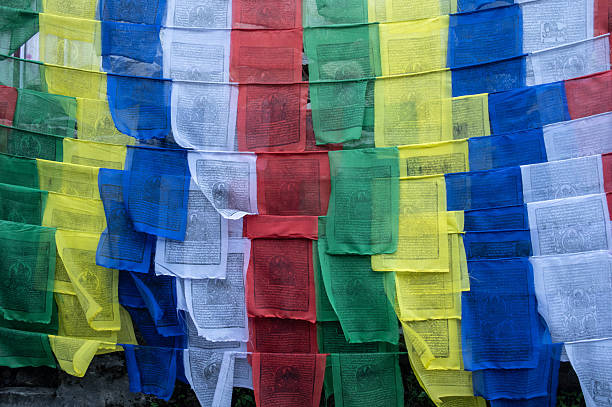 The prayer flags initiate peace and good tidings, their sacred mantras etched on the wind.