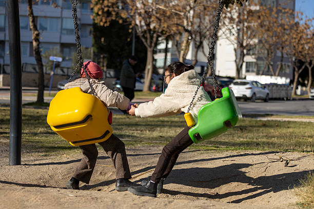 girls playing together on swings