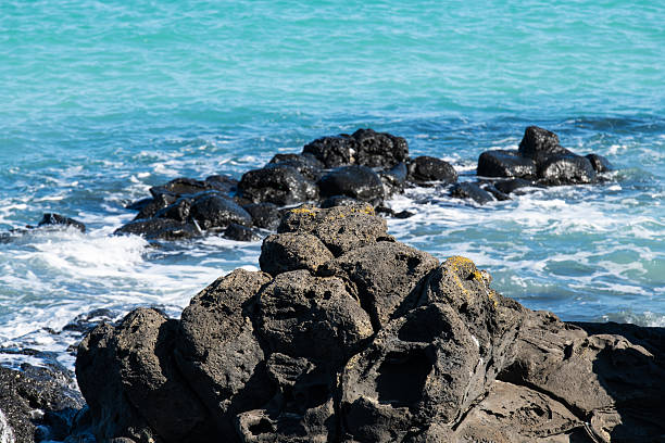 The Pancake Rocks and Blowholes are a coastal rock formation at Punakaiki on the West Coast of the South Island of New Zealand. They are a popular visitor attraction. The limestone of the Pancake Rocks has been uplifted and then eroded into the current landforms by a combination of two processes – karst erosion (a slow process where chemical erosion of the limestone occurs through the action of water flowing in joints and caverns), and coastal erosion (including the collapse of caverns).