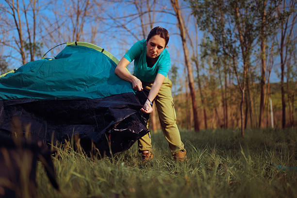 Backpacker encountering technical difficulties while trying to pitch camp without assistance