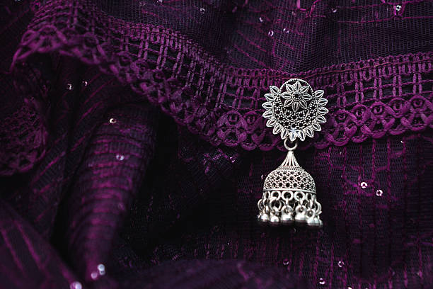 Vintage style indian earring on fabric background