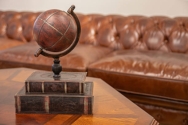 Close-up of small, old-fashioned globe against white background.